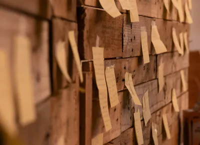 Sticky notes on a wooden wall from a working session
